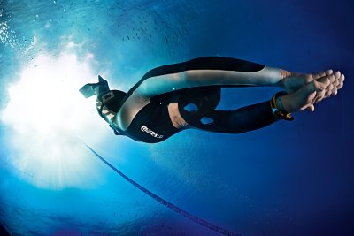 male freediver descending