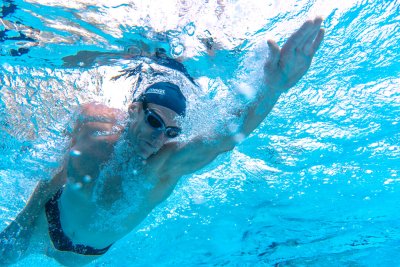 man swimming in pool