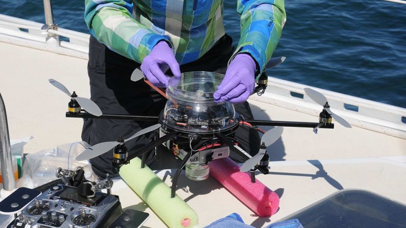 The researchers attach a sterilized petri dish to the top of the hexacopter to collect some of the whale blow.
(c) Véroniqe LaCapra, WHOI