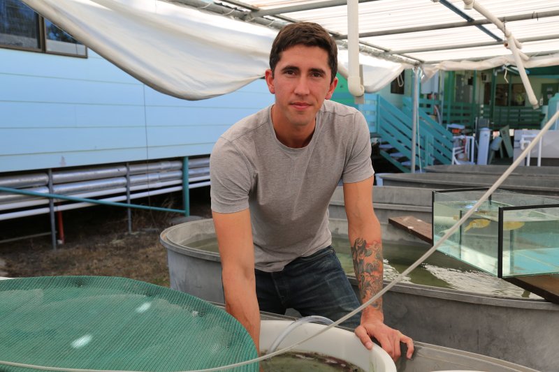 Biologist Blake Spady experiments with squid, (c) Blake Spady