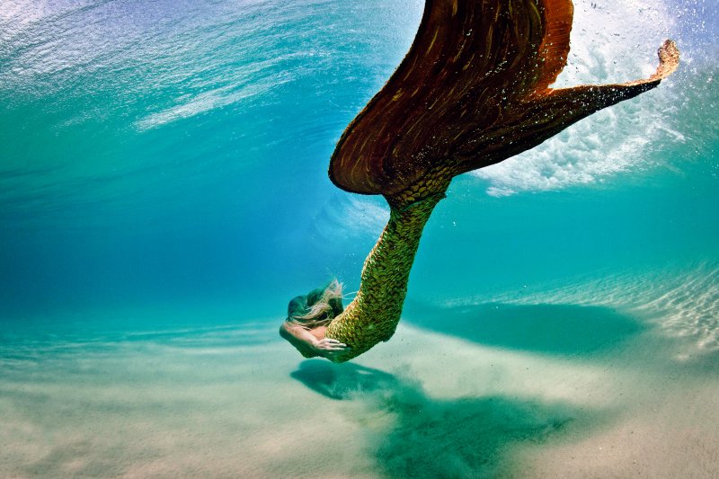 Underwater model posing as a mermaid professional during a portfolio photo shoot