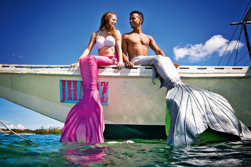 Mermaid professional connecting with instructors and performers at an aquatic community event